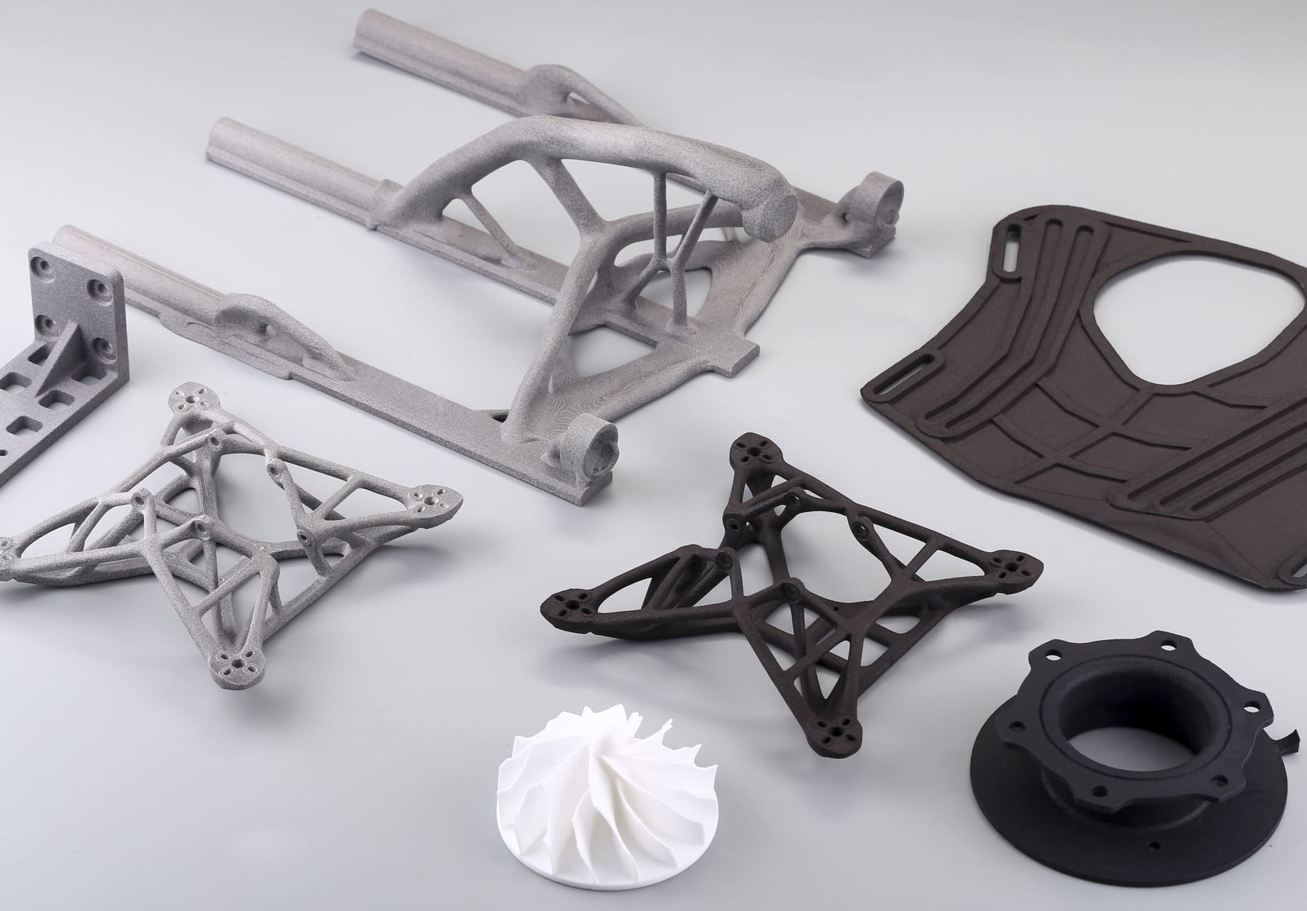 3d printed nylon parts in black, gray, and white